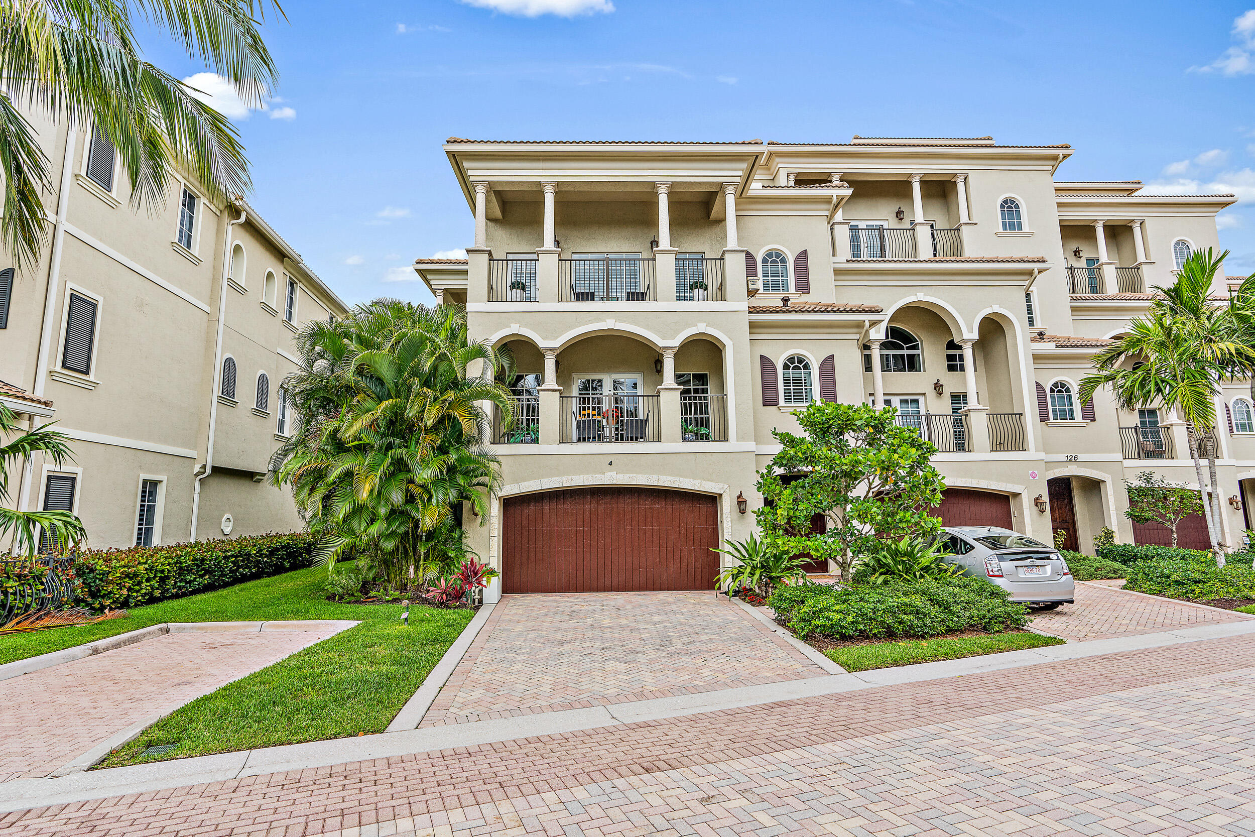 126 Tierra Lane, Unit 4 Jupiter, FL 33477 - Photo 27 of 45 a front view of a house with garden