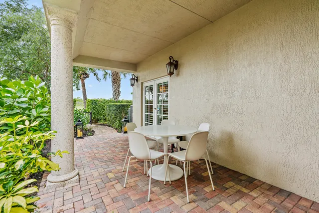 a view of a patio with table and chairs and potted plants