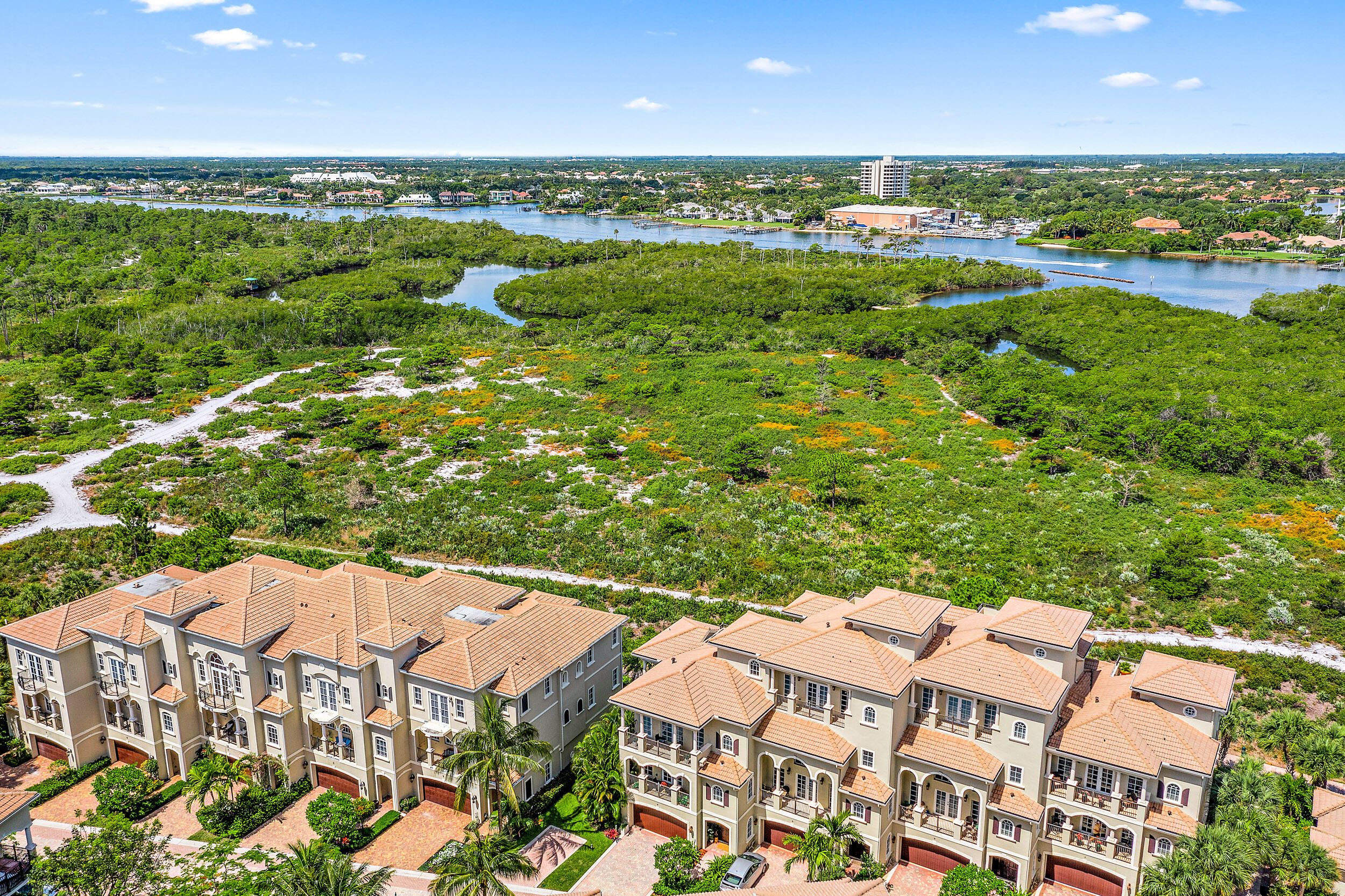 126 Tierra Lane, Unit 4 Jupiter, FL 33477 - Photo 37 of 45 an aerial view of residential houses with outdoor space and trees