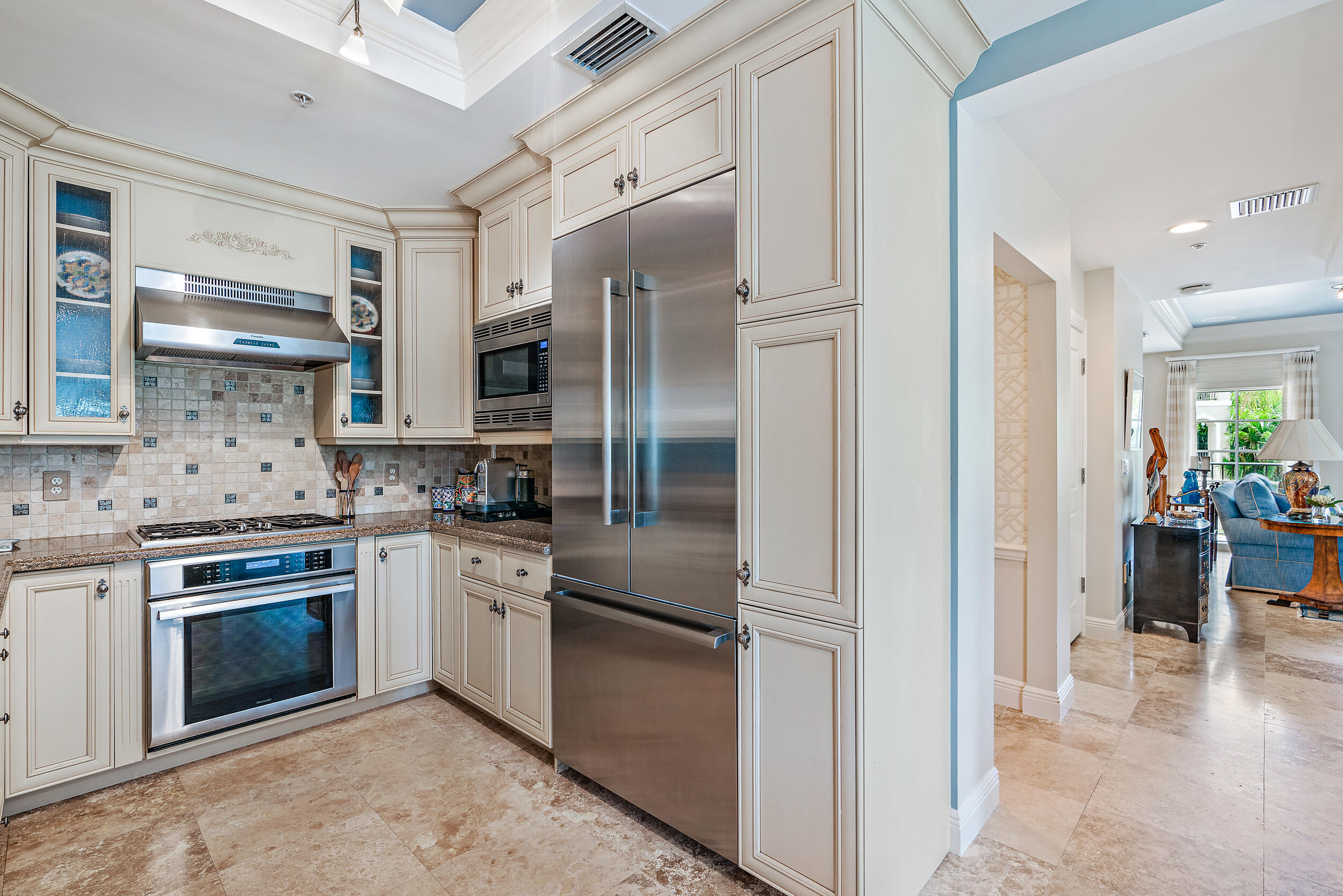 126 Tierra Lane, Unit 4 Jupiter, FL 33477 - Photo 8 of 45 a kitchen with stainless steel appliances granite countertop a refrigerator a stove and a sink