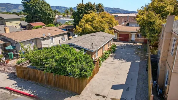 an aerial view of a house with wooden fence