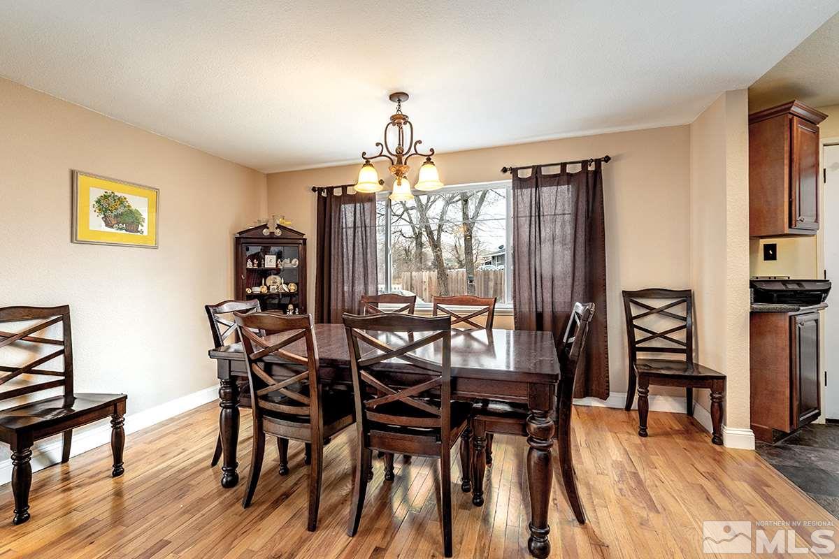 210 Rhodes Road Reno, NV 89521 - Photo 8 of 22 a view of a dining room with furniture and wooden floor