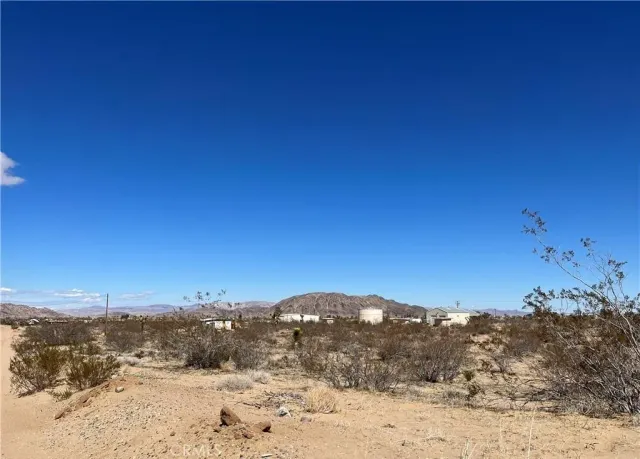 a view of ocean beach and mountain