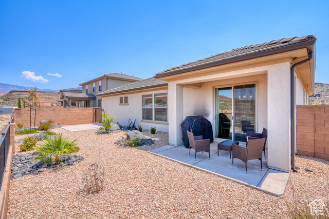1329 Paseos Street Washington, UT 84780 - Photo 23 of 35 Back of house with stucco siding, a patio, and a fenced backyard