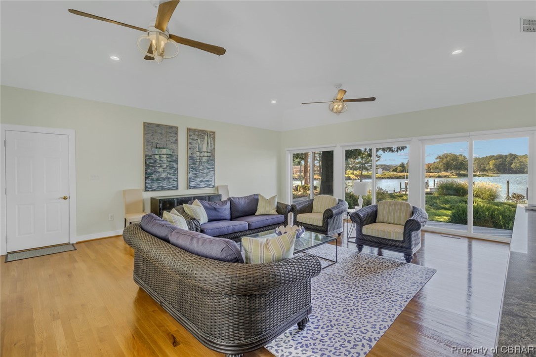 192 Bayberry Point Lane Kilmarnock, VA 22482 - Photo 30 of 49 Living room featuring a wealth of natural light, light hardwood floors, and ceiling fan