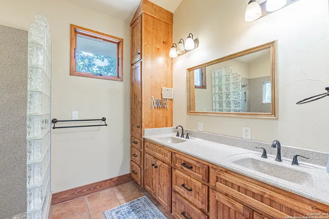 a spacious bathroom with double vanity sink and a mirror