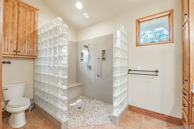 a bathroom with a toilet sink and shower