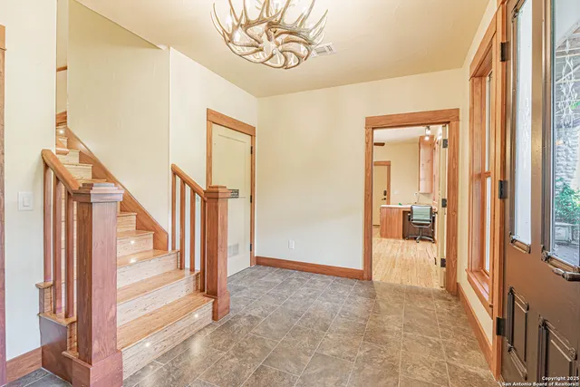 a view of a hallway with wooden floor and entryway