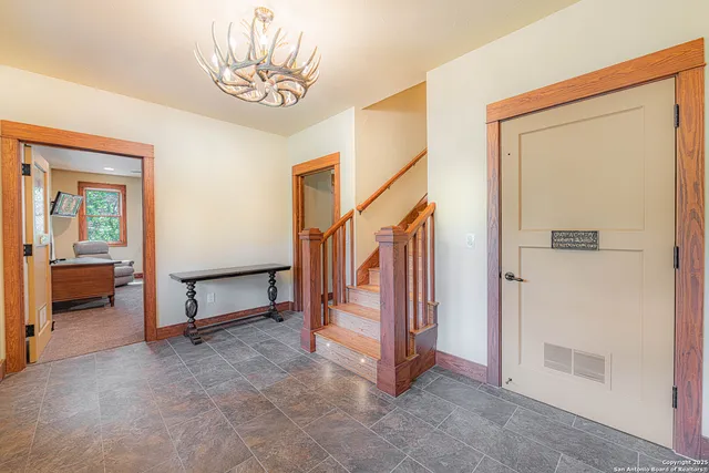 a living room with furniture a ceiling fan and a window