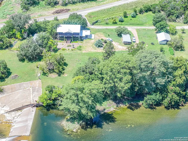a view of a house with pool and a yard