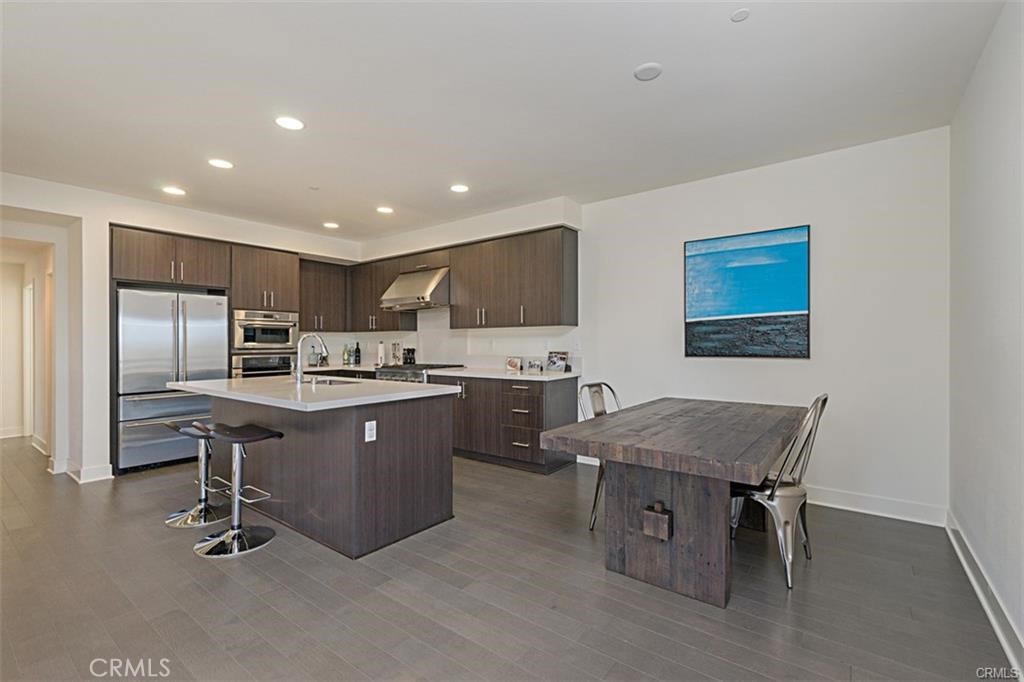 a kitchen with stainless steel appliances granite countertop a sink counter space and refrigerator