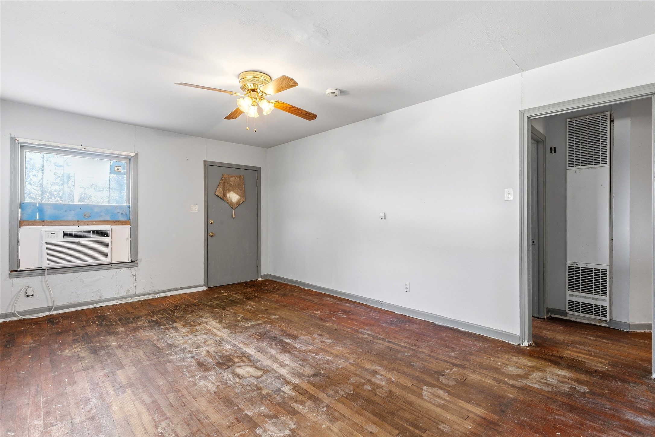 4900 Duval Street Austin, TX 78751 - Photo 16 of 25 Original oak floors anchor the living area and hint at the home’s vintage character. With renovation, this space could be transformed into a warm, inviting central gathering room.