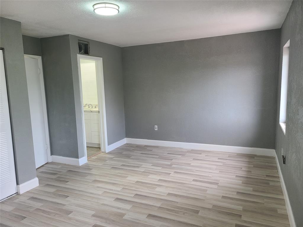 2775 Northwest 194th Terrace Miami Gardens, FL 33056 - Photo 11 of 37 an empty room with wooden floor and windows