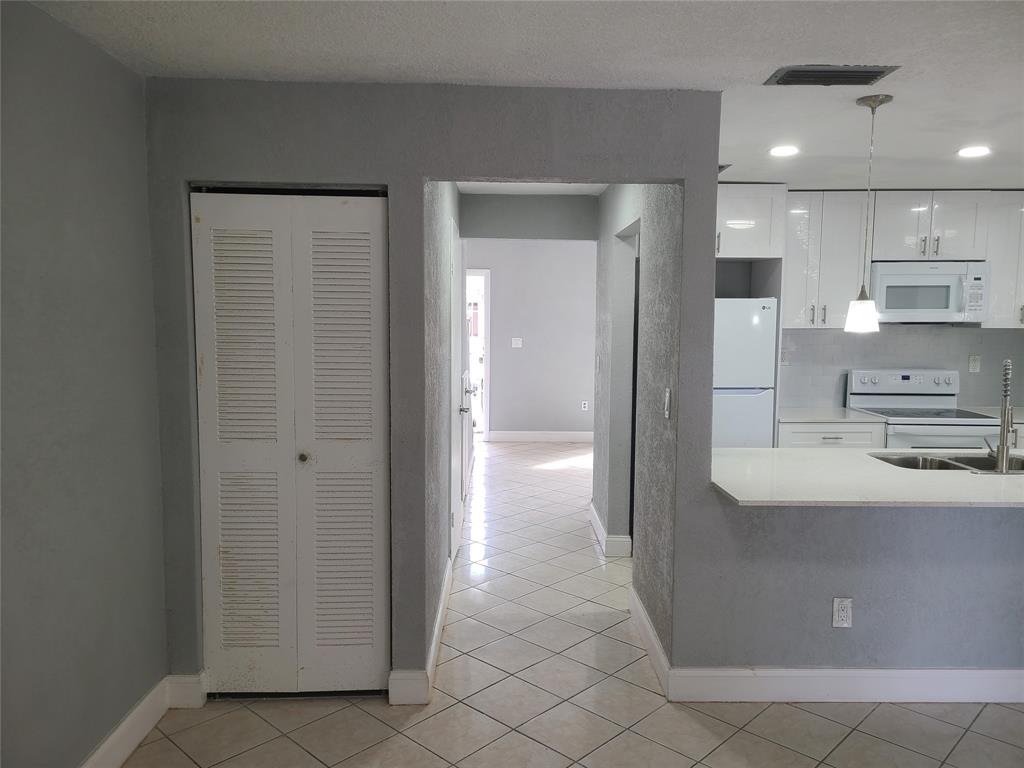 2775 Northwest 194th Terrace Miami Gardens, FL 33056 - Photo 26 of 37 a view of a kitchen with refrigerator and cabinets
