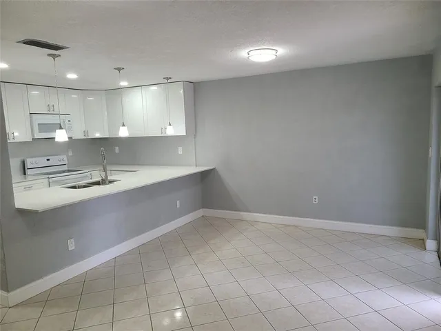 a view of a kitchen with a sink and cabinets