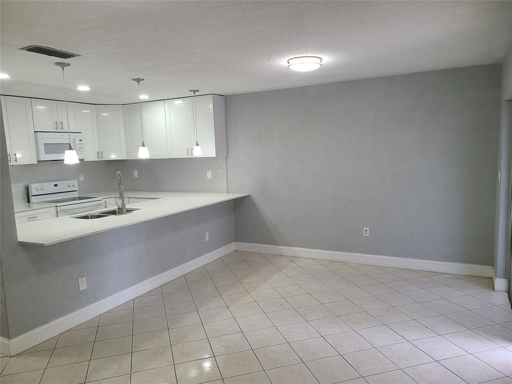 2775 Northwest 194th Terrace Miami Gardens, FL 33056 - Photo 28 of 37 a view of a kitchen with a sink and cabinets