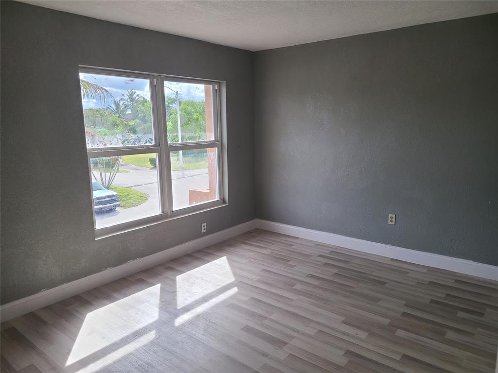 2775 Northwest 194th Terrace Miami Gardens, FL 33056 - Photo 3 of 37 an empty room with wooden floor and windows