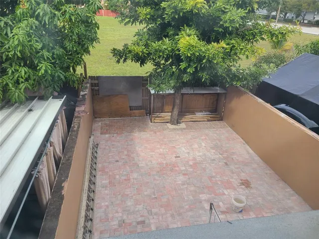 a view of backyard with outdoor seating and green space