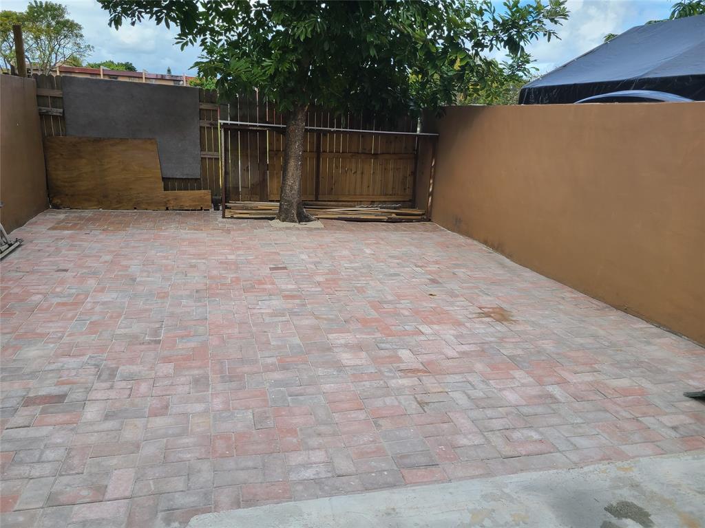 2775 Northwest 194th Terrace Miami Gardens, FL 33056 - Photo 36 of 37 a backyard of a house with trampoline