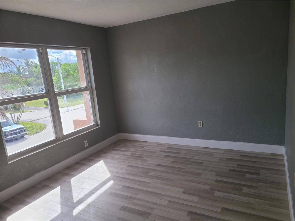 2775 Northwest 194th Terrace Miami Gardens, FL 33056 - Photo 4 of 37 a view of an empty room and wooden floor and windows