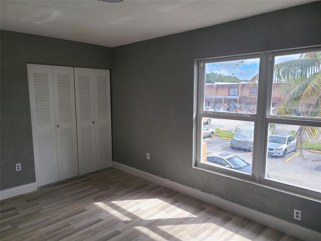 2775 Northwest 194th Terrace Miami Gardens, FL 33056 - Photo 5 of 37 an empty room with wooden floor and windows