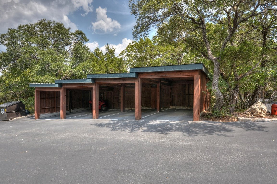 4711 Spicewood Springs Road, Unit 163 Austin, TX 78759 - Photo 14 of 17 a view of a house with a large tree and wooden fence