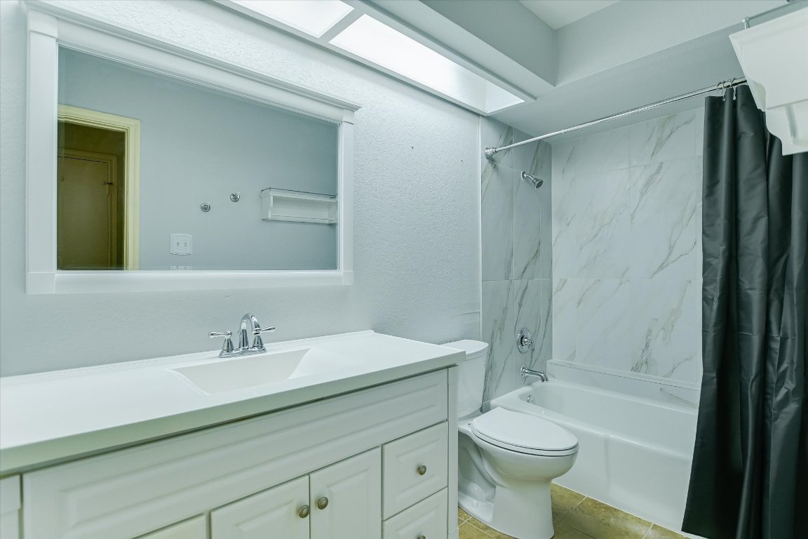 4711 Spicewood Springs Road, Unit 163 Austin, TX 78759 - Photo 9 of 17 a bathroom with a sink a toilet and shower