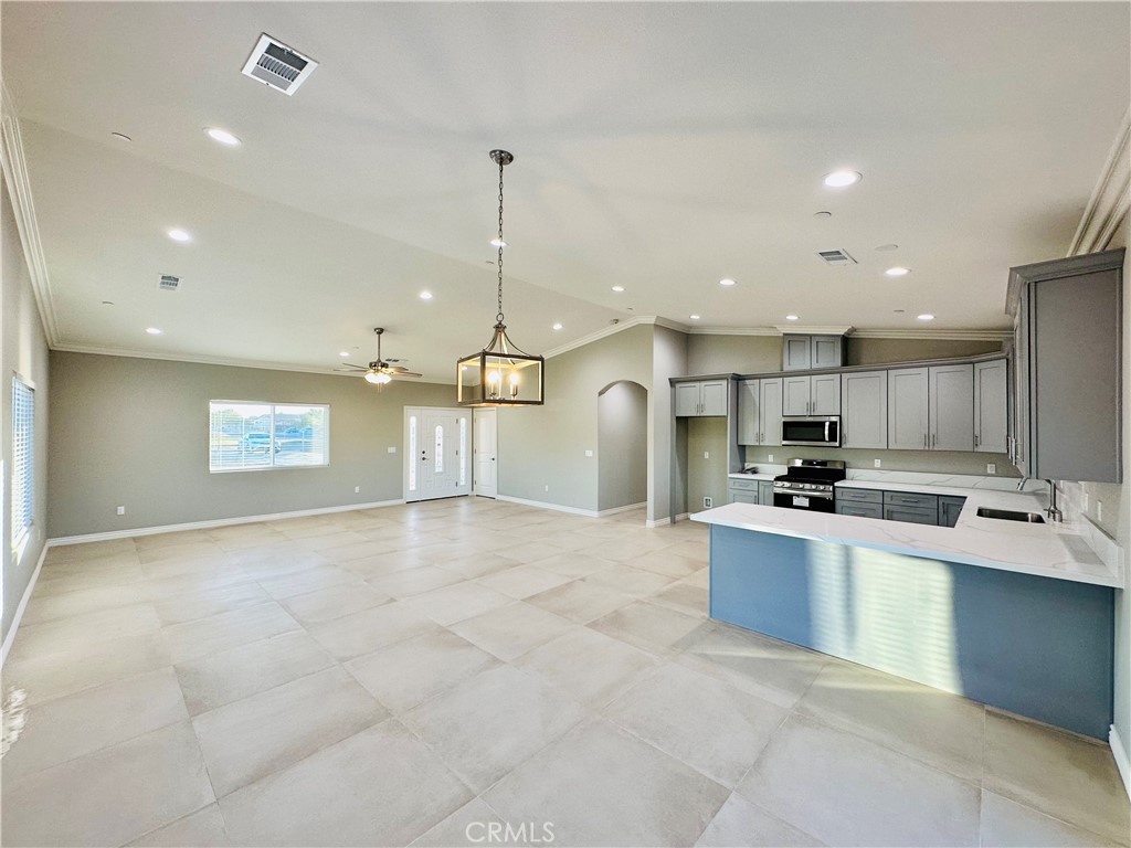 a view of kitchen with stainless steel appliances kitchen island a sink a stove a refrigerator and a stove