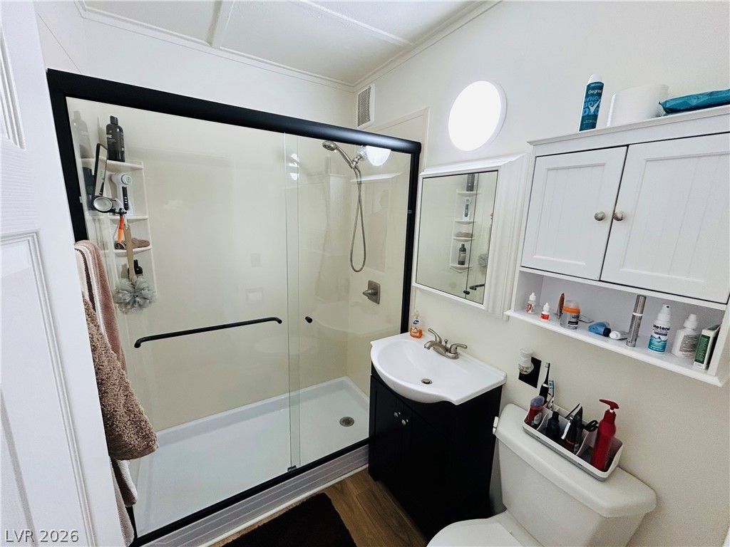116 West Basic Road Henderson, NV 89015 - Photo 25 of 39 A compact bathroom offers a stand-up shower with a sleek glass enclosure and a stylish vanity.