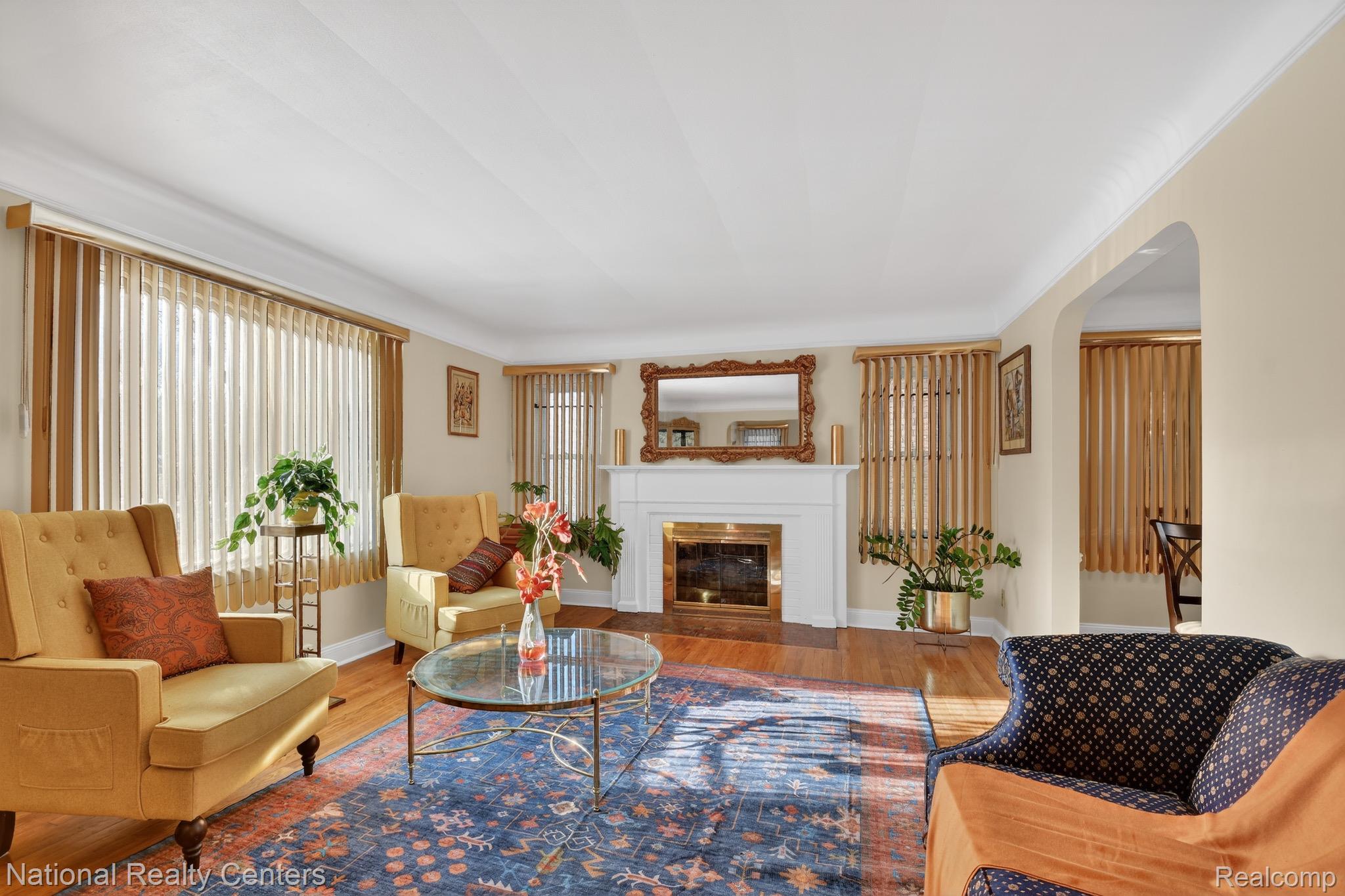 3956 Harvard Road Detroit, MI 48224 - Photo 9 of 44 Living room featuring wood finished floors, arched walkways, and a fireplace with flush hearth