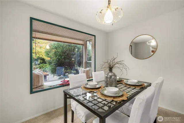 a view of a dining room with furniture wooden floor and chandelier