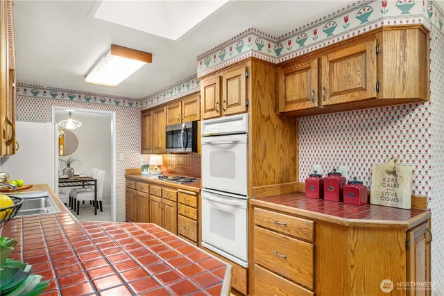 a kitchen with stainless steel appliances granite countertop a sink and cabinets