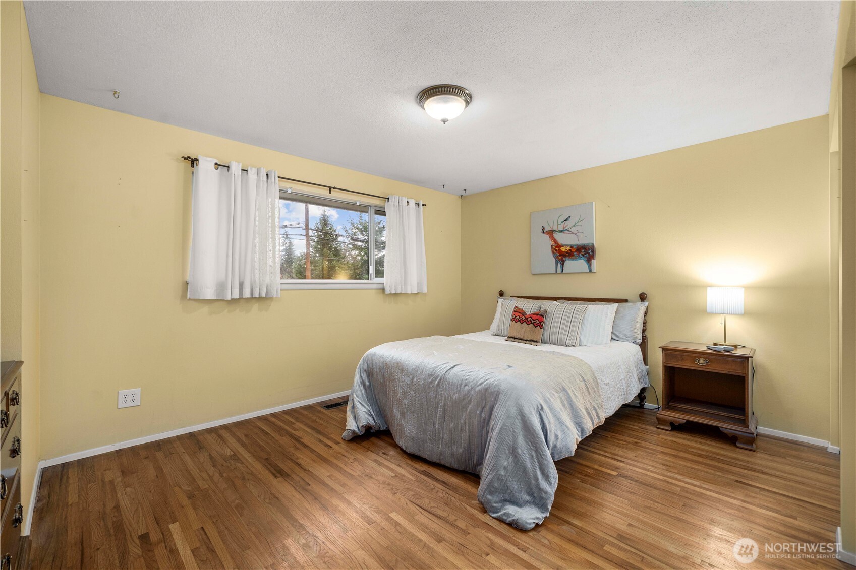 914 Alameda Avenue Fircrest, WA 98466 - Photo 22 of 40 a bedroom with a bed and a night stand
