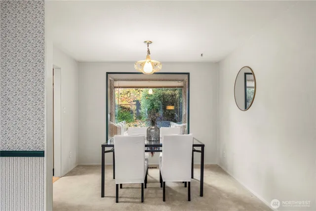 a dining room with furniture and a window