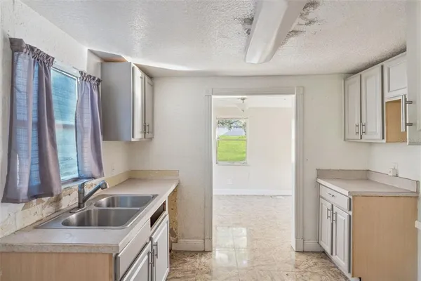 a kitchen with a sink stove and cabinets