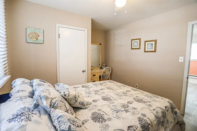 a bedroom with a bed and a painting on the wall