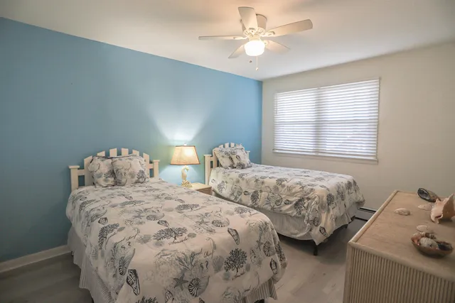 a bedroom with two beds and a chandelier