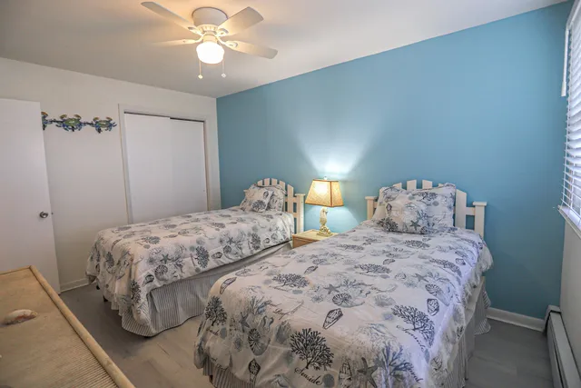 a bedroom with two beds and a chandelier