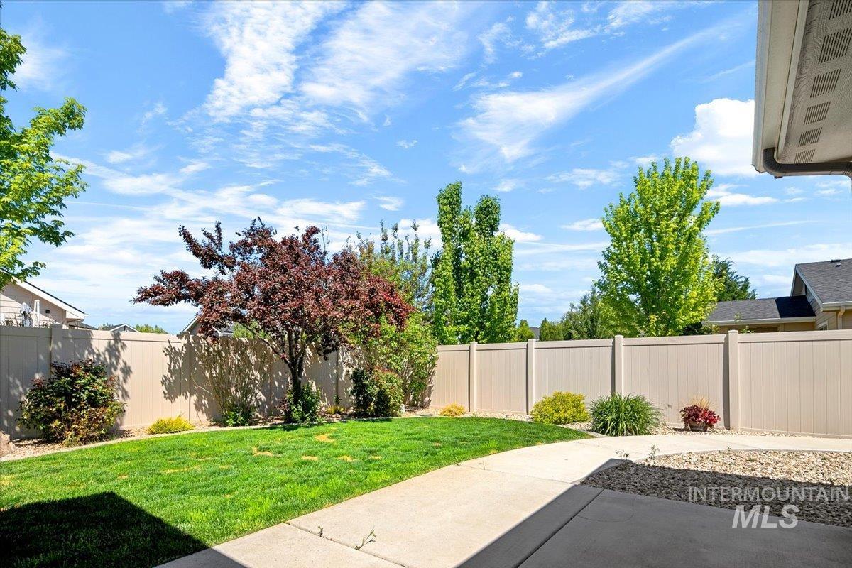 5850 West Rotherham Drive Eagle, ID 83616 - Photo 28 of 50 Spacious backyard featuring a covered patio with concrete flooring, a manicured lawn, and perimeter fencing