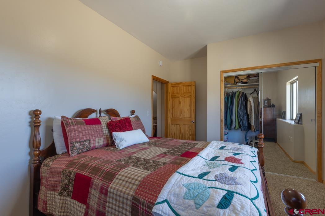1737 Roberts Ridge Drive Hesperus, CO 81326 - Photo 22 of 34 a bedroom with a bed and a mirror