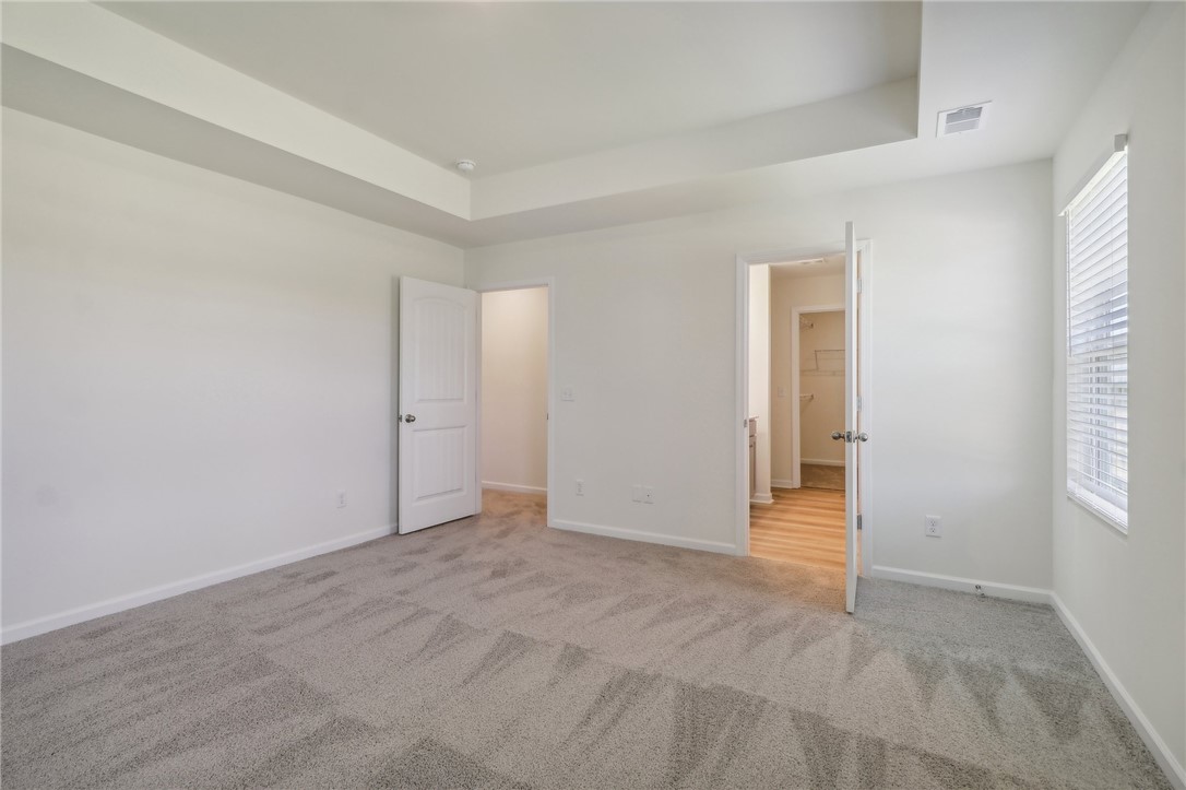 206 Bellflower Lane Pendleton, SC 29670 - Photo 19 of 27 This spacious bedroom offers comfortable carpeting and a large window, creating a serene living space.