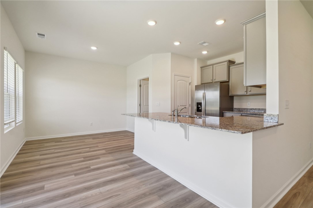 206 Bellflower Lane Pendleton, SC 29670 - Photo 4 of 27 This bright kitchen and living area features a breakfast bar, recessed lighting, and durable flooring.