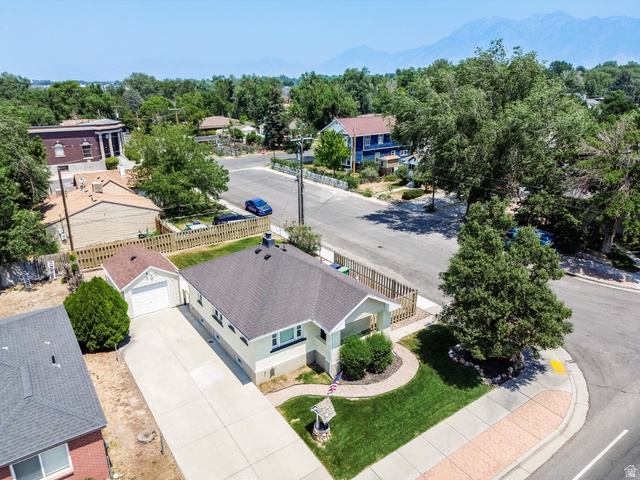 59 East 8680th Street South Sandy, UT 84070 - Photo 33 of 33 Single-story residence featuring a paved driveway, attached garage, and a lush green lawn