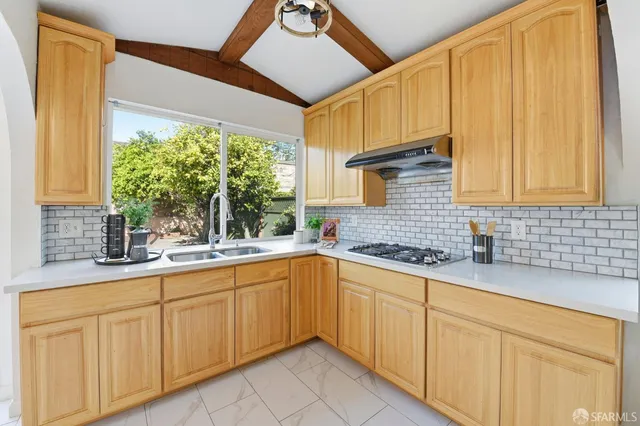 a kitchen with sink cabinets and window
