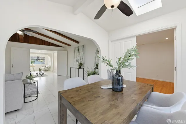 a dining room with table chairs and kitchen view