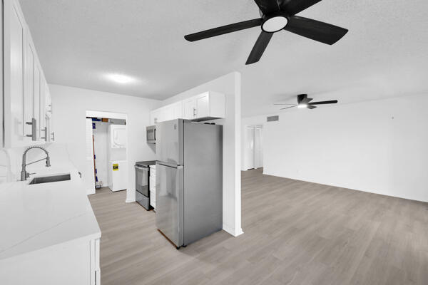 150 Pineview Road, Unit J6 Jupiter, FL 33469 - Photo 12 of 27 a view of a kitchen with a sink and refrigerator