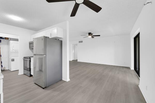 150 Pineview Road, Unit J6 Jupiter, FL 33469 - Photo 13 of 27 a view of a refrigerator in kitchen and white walls