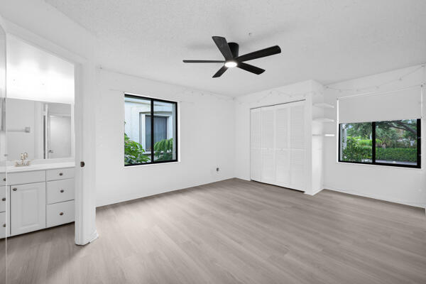 150 Pineview Road, Unit J6 Jupiter, FL 33469 - Photo 15 of 27 a view of an empty room with a window and wooden floor