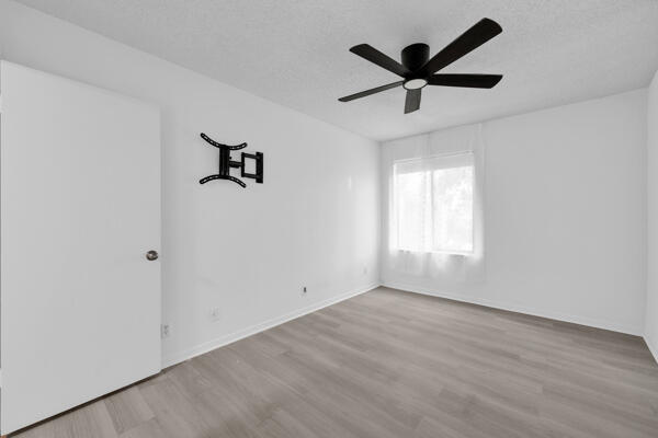 150 Pineview Road, Unit J6 Jupiter, FL 33469 - Photo 21 of 27 an empty room with ceiling fan and window
