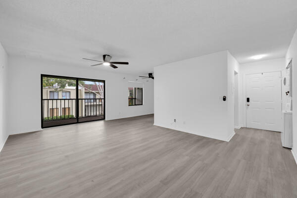150 Pineview Road, Unit J6 Jupiter, FL 33469 - Photo 4 of 27 a view of an empty room with wooden floor and a window
